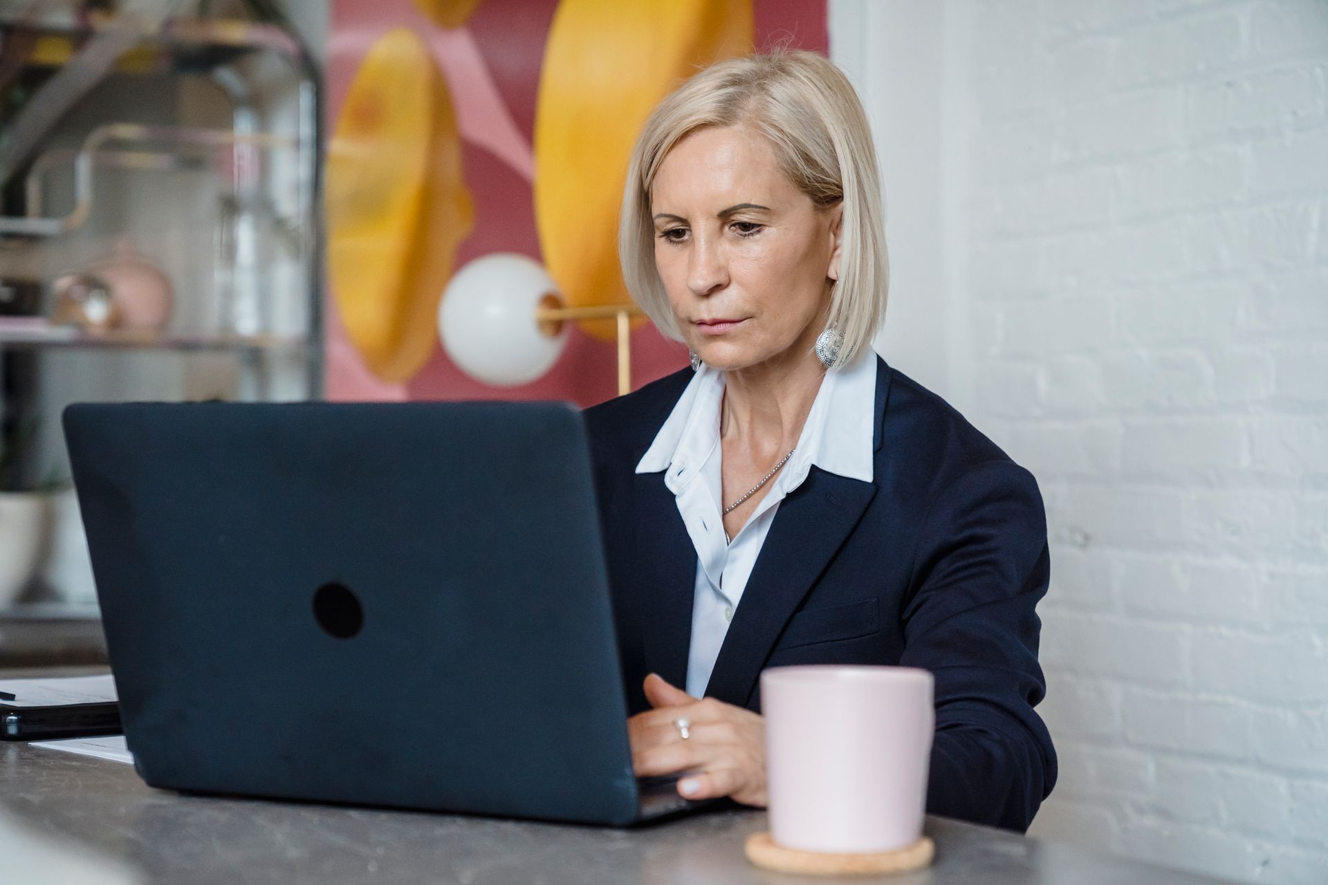 A professional woman working on a laptop