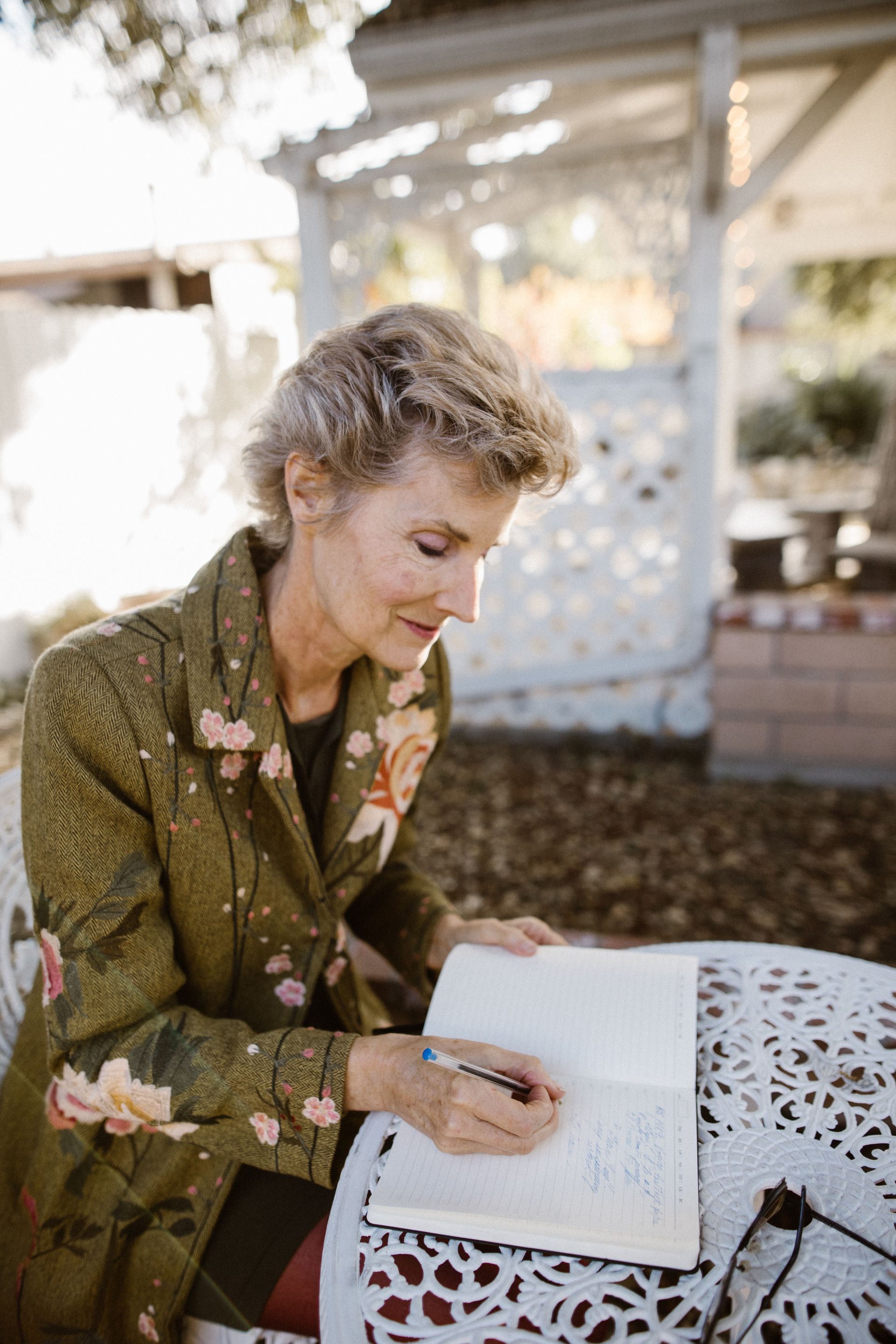 A woman writing in a notebook outdoors